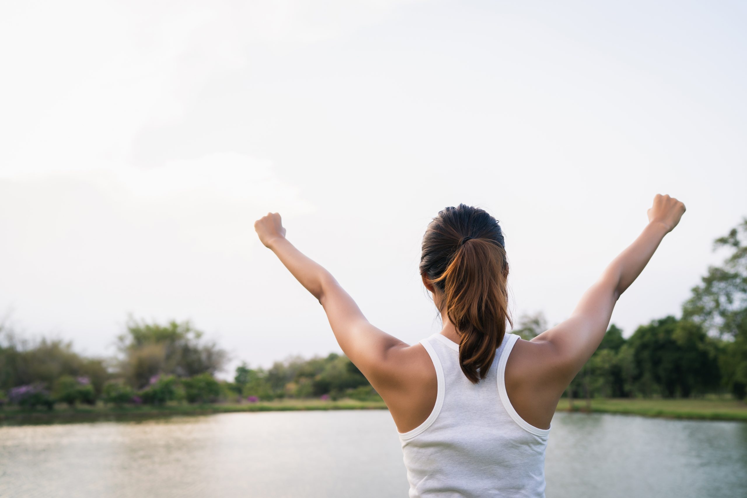Healthy young Asian runner woman warm up the body stretching bef
